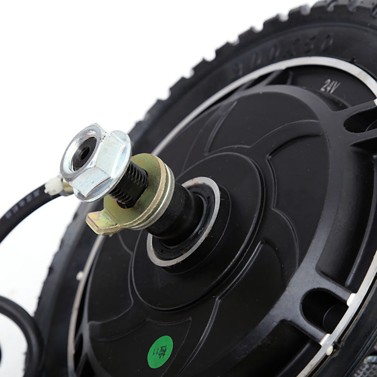 Close-up of a black wheel with a metal hub and bolts on a white background
