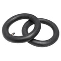Two black inner tubes on a white background