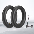 Two black scooter tires with a small electric scooter on a light gray background