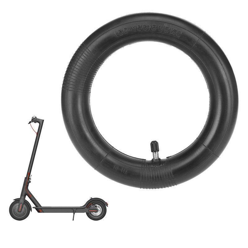 Black scooter tire and rim on a white background
