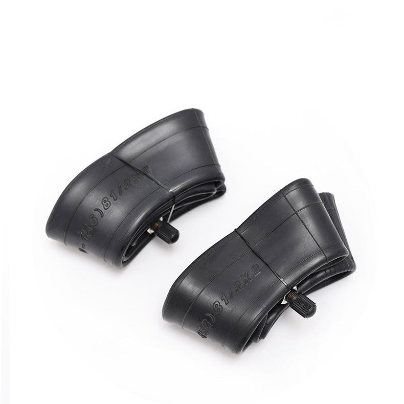 Two black bicycle inner tubes on a white background